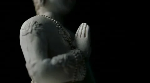 Close up of rotating Buddha figure, tilt up against isolated black background Stock Footage 65523830