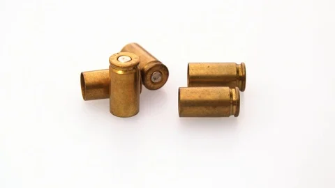 Close Up of rotating bullet shells on white background Stock Footage 117869523
