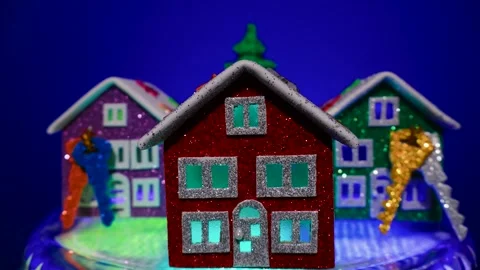 Close-up of a rotating Christmas tree surrounded by houses with keys Stock Footage 306043634
