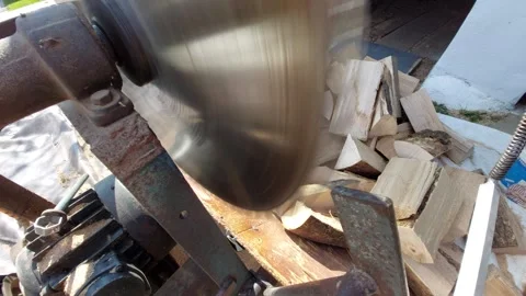 Close-up of a Rotating Circular Saw Blade Cutting Through a Wood Log Stock Footage 333642701