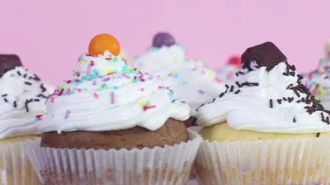 Close up of rotating cup cakes with white cream served for party 스톡 동영상 147963351