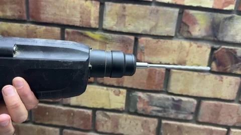 Close up rotating drill bit in motion, power tool operation and construction Stock Footage 337120405