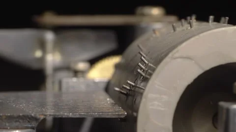 Close-up of a rotating drum of an old mechanical music box to play music. Stock Footage 164521130
