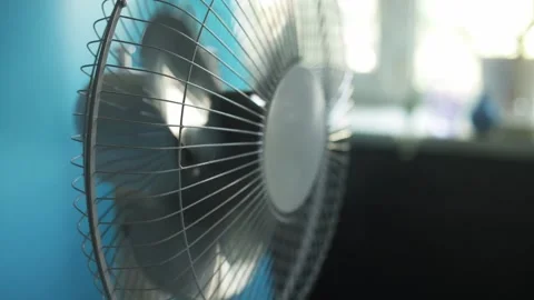 Close-up of a rotating electric fan creating a gentle breeze on a warm day Stock Footage 340265539