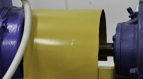 Close up of rotating element of the engine colored in blue and yellow. Media Foto stock