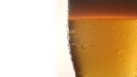 Close up of Rotating Glass with Light Beer 動画素材 125462774