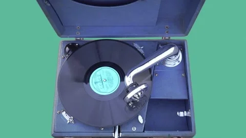 Close-up of a Rotating Gramophone Record on an Old Gramophone on a Turquoise Stock Footage 251785903