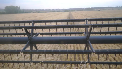 Close up rotating knifes of combine riding through countryside. Grain harvester Stock Footage 326685437