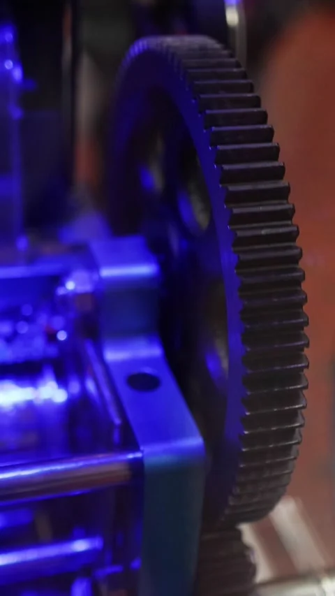 Close Up of Rotating Mechanical Gears Under Blue Lighting Stock Footage 327441541