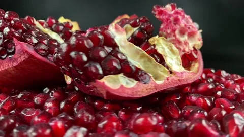 Close-up rotating open pomegranate pieces ruby juicy arils at studio Stock Footage 233096173