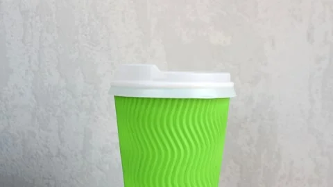 Close-up of rotating paper coffee cup on grey concrete Video stock 144661801
