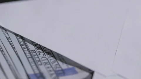 Close-up of a rotating paper envelope with hundred-dollar bills. Stock Footage 120633001