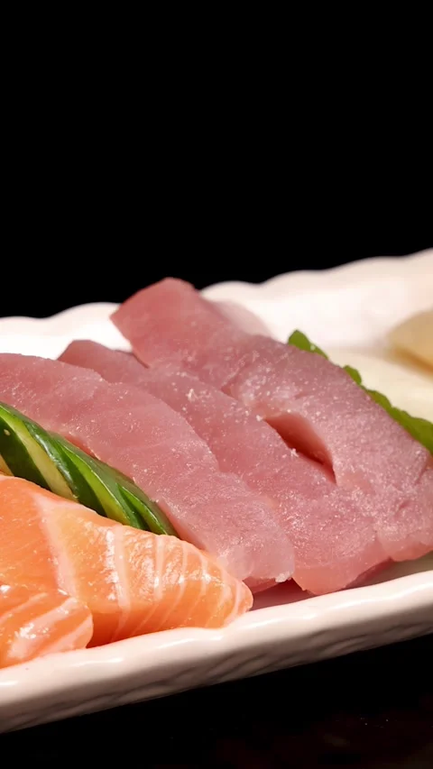 Close-Up Rotating Plate of Assorted Sashimi on Black Background 库存影片 314040166