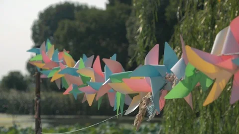 Close-up of rotating rainbow colored windmills Video stock 100579271