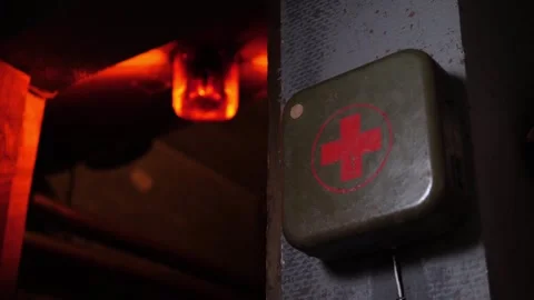 Close-up of a rotating red emergency siren lamp on the wall of a dark tunnel. Stock Footage 287585609