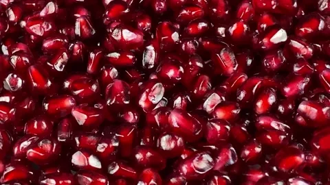 Close-up rotating red fresh pomegranate arils at studio Stock Footage 233096259