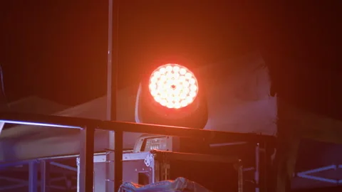 Close-up of rotating RGB circular stage light in concert setting Stock Footage 313793857