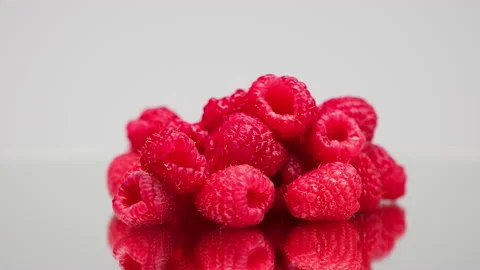 Close-up of rotating ripe red raspberry isolated on light grey background Stock-Footage 158931220