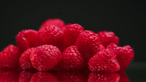 Close-up of rotating ripe red raspberry isolated on black background, making jam Stock Footage 159131615