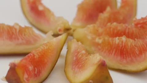 Close rotating shot fig fruit slices isolated over white background Video stock 148211182
