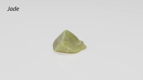 A close-up rotating shot of a natural jade stone, showcasing its light gree.. Stock Footage 332826799
