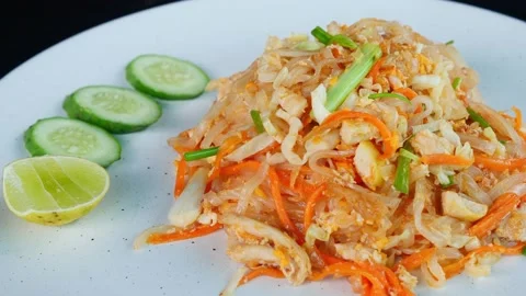 Close-up rotating shot of roasted vegetables served on a white plate with slices Stock Footage 220241874
