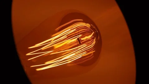 Close-up on rotating table lamp with a vintage light bulb Stock Footage 85340415