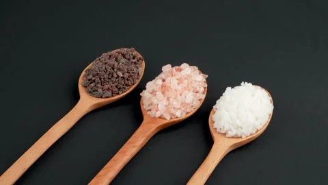 Close Up Rotating Three Gourmet Salts On Wooden Spoons Video stock 331845800