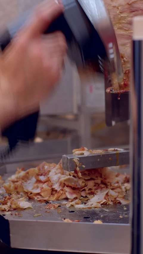 Close-up of rotating vertical spit being shaved with horizontal blade Stock Footage 336535812