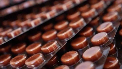 Close rotating view of brown color tablets Stock Footage 147699442