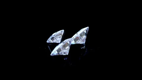 Close-Up Rotating View of Four Sparkling Princess Cut Diamonds on Black Stock Footage 314660633