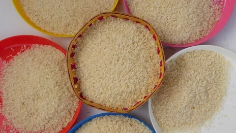 Close rotating view of plastic bowls filled with brown rice Stock Footage 147693683