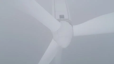 Close-Up of Rotating Wind Turbine Hub and Blades in Thick Fog Stock-Footage 332711775