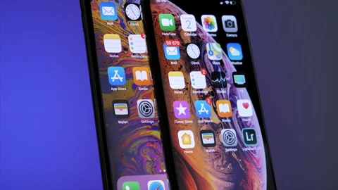 Close-up rotation on board as hero objects of two latest iPhone 12 pro and 12 Stock Footage 148057176
