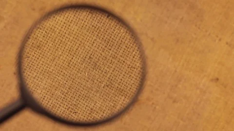 Close-up of the rotation of the burlap cloth under the magnifying glass. Video stock 82934667