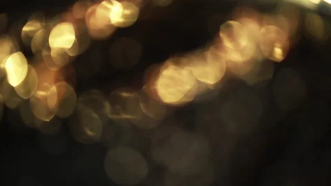 Close-up of a rotation in a circle of yellow bokeh lights. 스톡 동영상 134996812