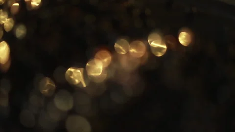 Close-up of a rotation in a circle of yellow bokeh lights. 스톡 동영상 134997029