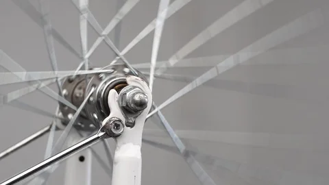 Close-up rotation of the front wheel of a bicycle, front hub with spokes on a Stock Footage 115125827