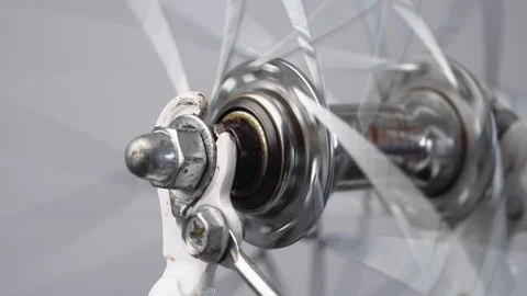Close-up rotation of the front wheel of a bicycle, front hub with spokes on a Stock Footage 115274811