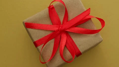 Close up rotation of gift box on golden background. Minimalist Christmas concept Stock-Footage 221124268