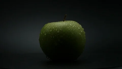 Close-up rotation green apple covered by drops of water. 動画素材 108969957