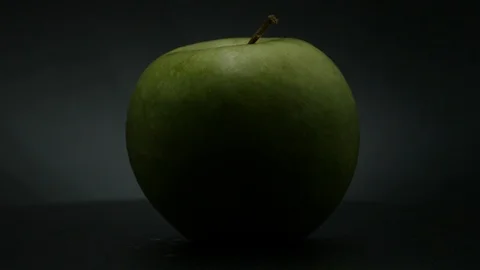 Close-up rotation green apple covered by drops of water. 動画素材 108969975