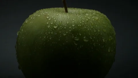 Close-up rotation green apple covered by drops of water. 動画素材 108969988