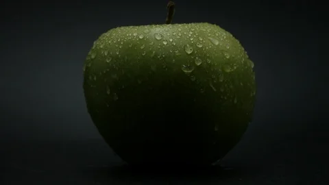 Close-up rotation green apple covered by drops of water. 動画素材 108970251