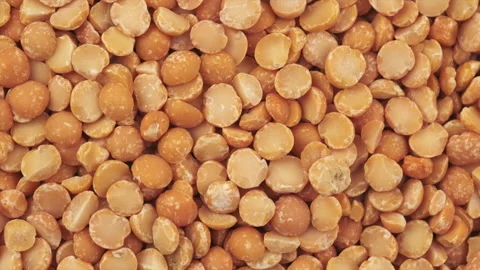 Close up of rotation many dried peas. Round yellow peas for cooking porridge Stock Footage 284617203