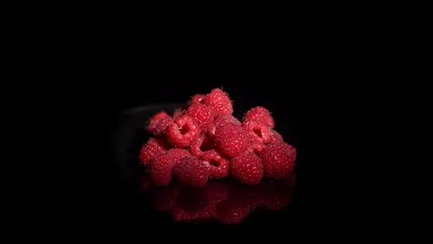 Close-up rotation red raspberries on a black background. Stock Footage 113139644