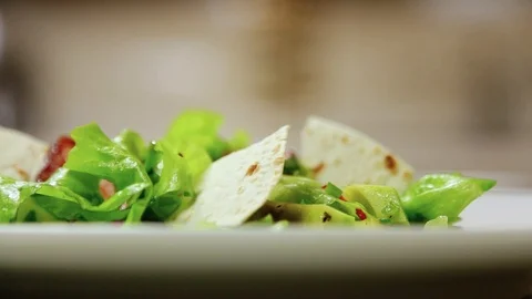 Close up rotation view of avocado salad with pita and cooked bacon on a table Video stock 107395959