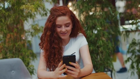 Close up rotation view of curly redheaded girl chilling in a café with coffee Video stock 114249724