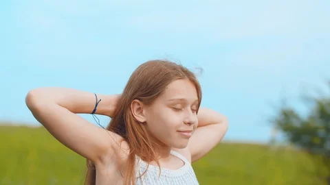Close up rotation view of pretty cheerful little teenage girl enjoying the wind Stock Footage 113045519