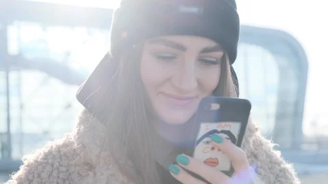 Close up rotation view of pretty smiling young woman in trendy outfit using her Stock Footage 107387187